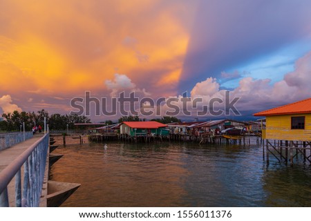 Beautiful Sunset view over Tanjung Aru Water village with local fisherman boat at Tanjung Aru, Kota Kinabalu, Sabah, Malaysia