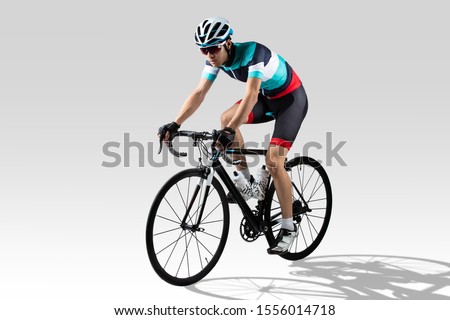 Handsome asian riders he is cycling in the studio. Royalty-Free Stock Photo #1556014718