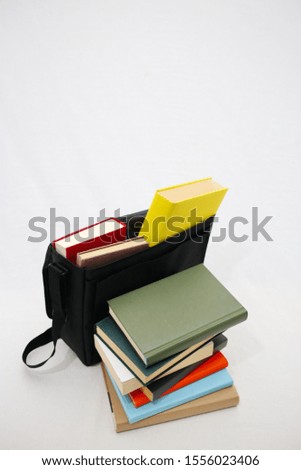 Books and school bag on white background