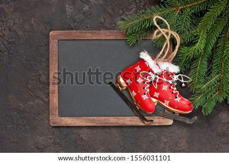 Christmas greeting card with fir tree, decorations, blackboard on dark background, top view