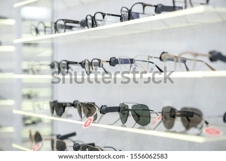 Various glasses. Close up of various glasses lying on the shelves in spacious new optical store