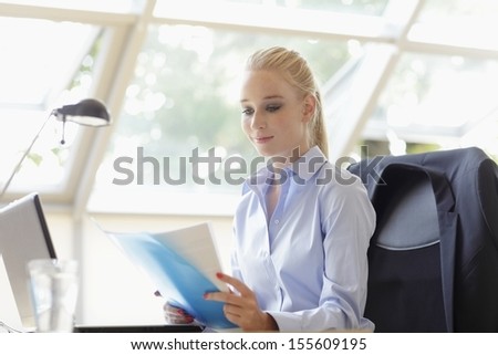 Beautiful businesswoman working in her office