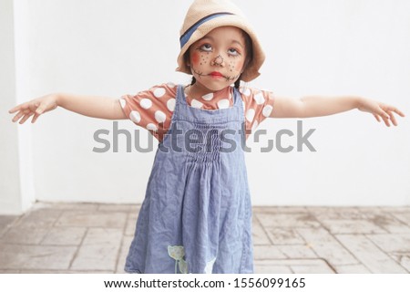 A cute 4 years old asian girl dressed up as a scarecrow during Halloween party celebration in Malaysia.