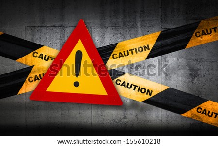 Warning sign with exclamation mark on striped caution tape