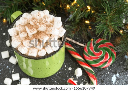 hot cocoa with marshmallow in a green Cup
