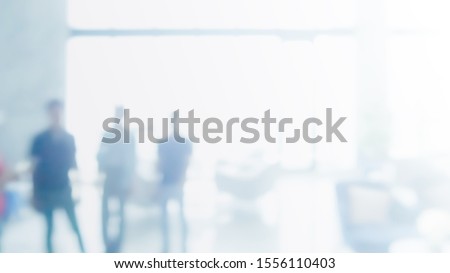 Abstract blurred interior modern office space with business people working banner background with copy space.