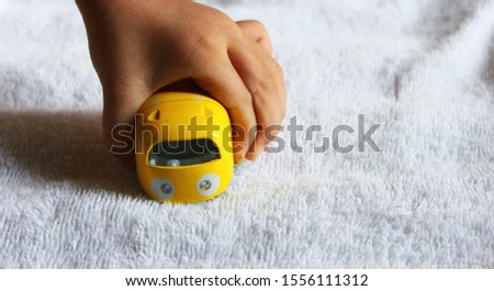 hand holding a yellow toy van 