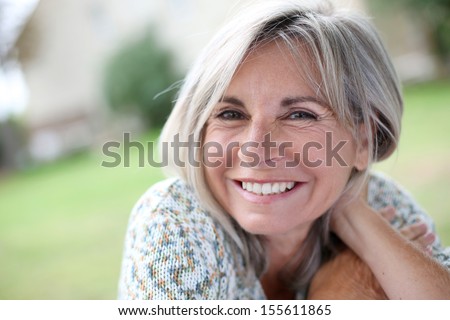 Portrait of serene mature woman in garden Royalty-Free Stock Photo #155611865