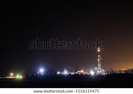 The rig was used to explore the gas and oil field at night against the starry sky. drilling rig and the starry sky