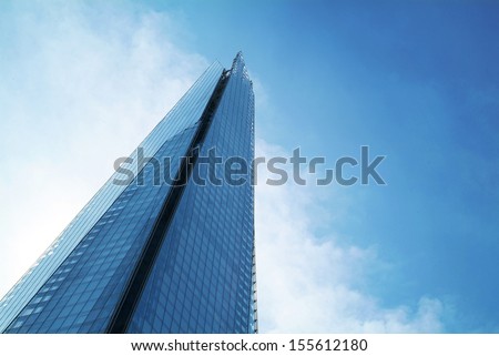 The Shard towering over London, photographed in London, UK. Built in 2012 and standing 306 meters tall, the Shard is currently the tallest building in the European Union and a new London attraction. Royalty-Free Stock Photo #155612180