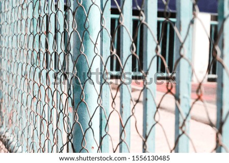 Steel wire mesh separates the entrance to the field