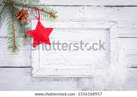 Christmas background with framed white message board, fir tree branches and red star