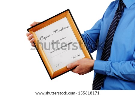 businessman holding certificate in a wood picture frame