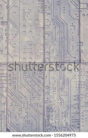The texture of a stone wall with a carved pattern of a digital computer chip