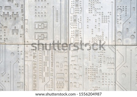 Concrete wall background with a print of a computer chip, modern electronics in stone