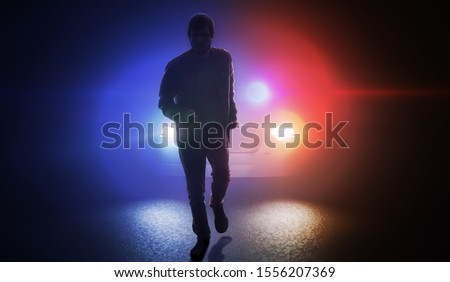 Silhouette of man running away from police car at night. Royalty-Free Stock Photo #1556207369
