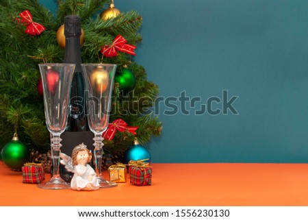 Christmas composition from champagne bottle with glasses and place for text.