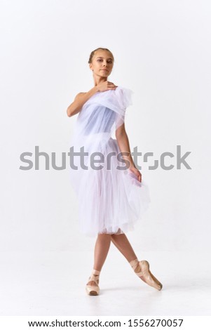 Beautiful woman ballet dancer in bright clothes on an isolated background