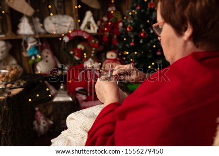 Grandma sews to knit in a Christmas arrangement
