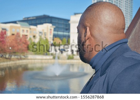 Man looking at lake and surrounding landscape