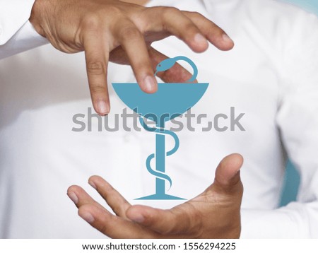 Conceptual photo of safety and health, life insurance. Image of a snake entwining a glass. Symbol of medicine.