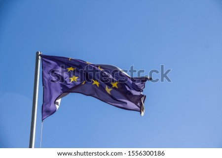 A European flag in the blue sky