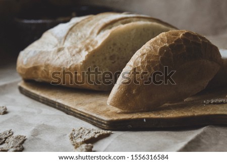 Freshly baked bread and oatmeal on a wooden Board.