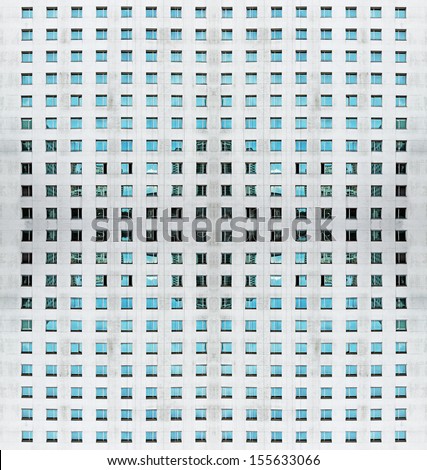 An abstract architectural facade of a concrete building with symmetrical windows, for textural background. 