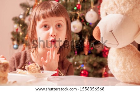 Christmas picture of little beautiful girl with a teddy bear 