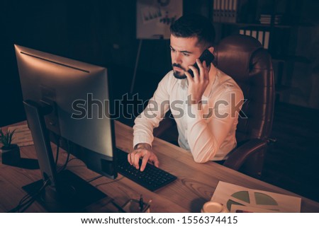 Photo of thoughtful man communicating with his business partner about solving all financial problems they observe in their company in coworking