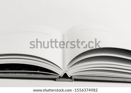 An open book on a table. Copy space