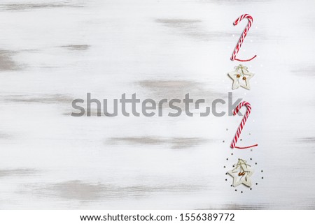 New year 2021. Merry Christmas and Happy Holidays greeting card. Christmas composition. Red and gold decorations on wood white background. Winter, new year concept. Flat lay, top view, copy space