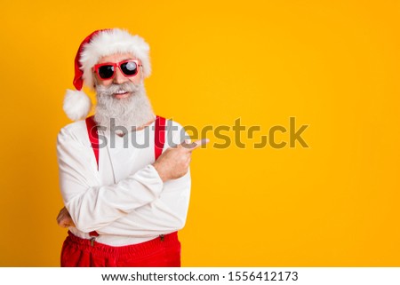 2020 christmas resolution discounts! Funny funky grey hair santa claus in red hat point index finger indicate x-mas time sales isolated over yellow color background