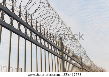 rusty barbed wire fence in sunny day.