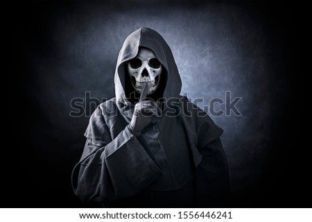 Grim reaper showing hush sign Royalty-Free Stock Photo #1556446241