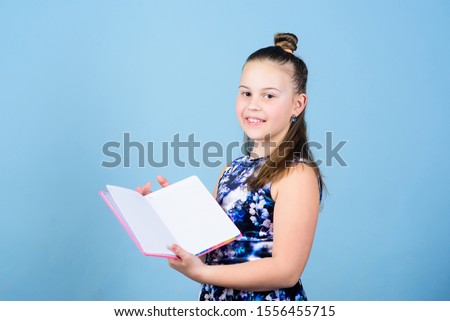 Keeping her secrets in diary. Child cute girl hold notepad or diary blue background. Childhood memories. Diary for girls concept. Note secrets down in cute girly diary journal. Keeping secrets here.