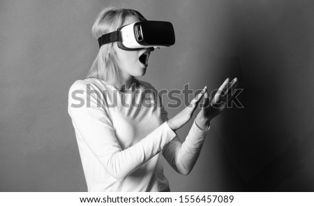 Woman with glasses of virtual reality. 3d technology, virtual reality, entertainment, cyberspace and people concept - young woman with virtual reality headset or 3d glasses. Woman using VR device