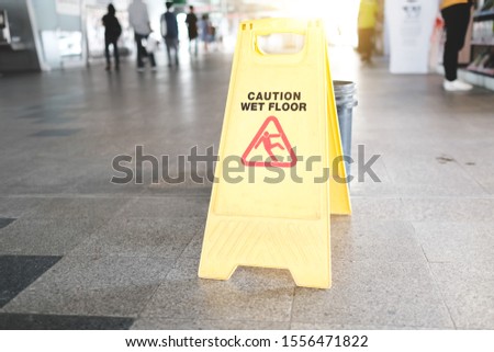 Sign showing warning of caution wet floor at fountain.