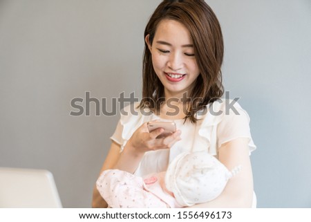 japanese mother carrying a baby in her arms
