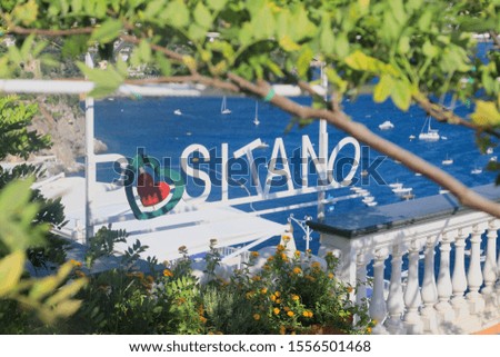 Positano Amalfi coast sign in front of the sea