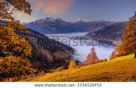 Incredible Nature Landscape., foggy morning during sunrise at Alpine lake in autumn. Colorful Sky over the Zeller Lake in Zell am See, Salzburger Land, Austria. Creative image. Natural Background
