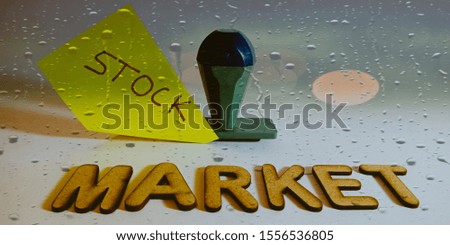 stock market business related terminology displayed with stamp paper slip on water drop abstract background 