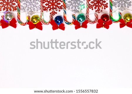 New Year greetings on a blue-blue background, with Christmas tree toys, sweets, bows, Christmas tree garland and snowflake. Beautiful christmas background. Merry Christmas.