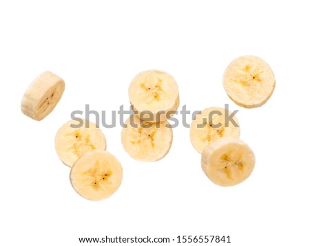 Many banana slices falling, isolated on white background with clipping path. Studio shoot. Royalty-Free Stock Photo #1556557841