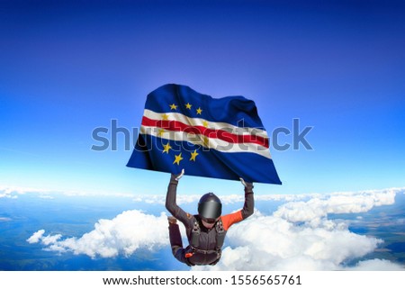Cape Verde flag. Flag in skydiving. People in free fall grab flag of Cape Verde. Patriotism, men and flag.
