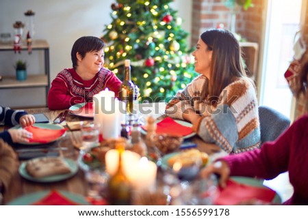 Beautiful family smiling happy and confident. Eating roasted turkey celebrating christmas at home