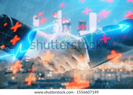 Double exposure of heart drawing on city view background with handshake. Concept of medical education