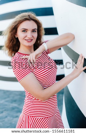 Girl in a striped dress on a striped background