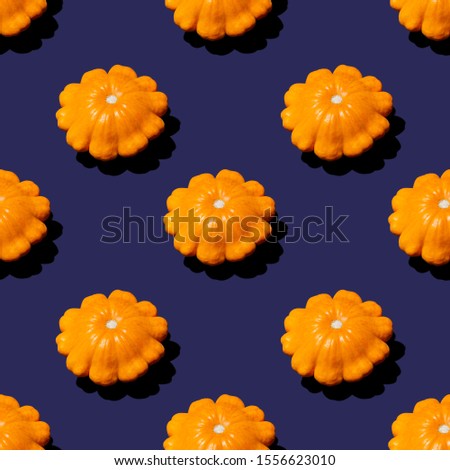 Seamless clip art orange pumpkin isolated on blue pattern.