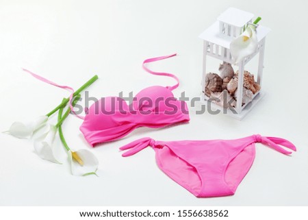 Swimsuit (bra and panties) with lilies and seashells in white lamp